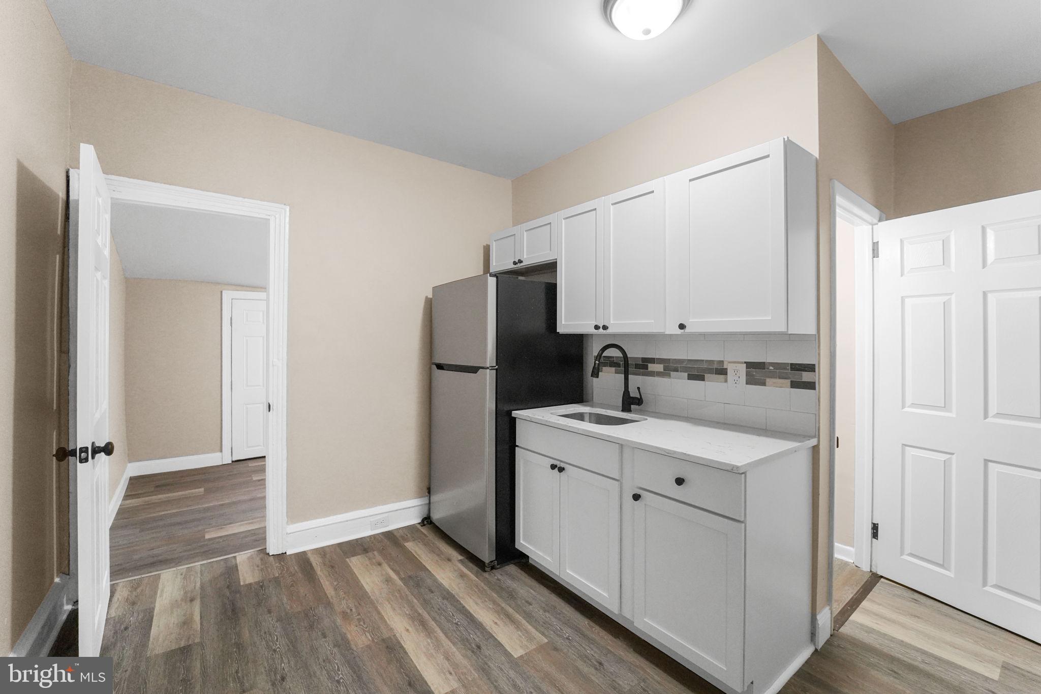 237 Morris Street Gloucester City, NJ 08030 - Photo 11 of 44 a kitchen with white cabinets and refrigerator