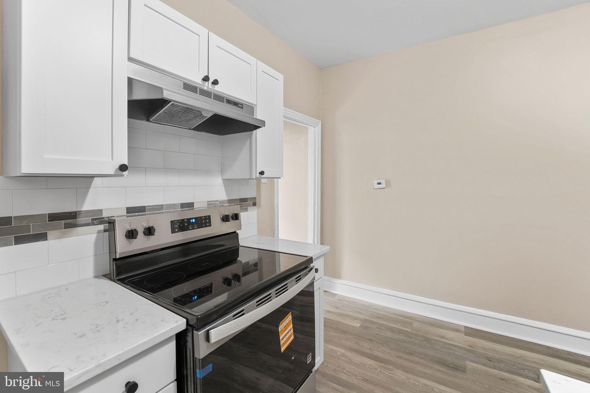 237 Morris Street Gloucester City, NJ 08030 - Photo 12 of 44 a kitchen with a stove and a microwave