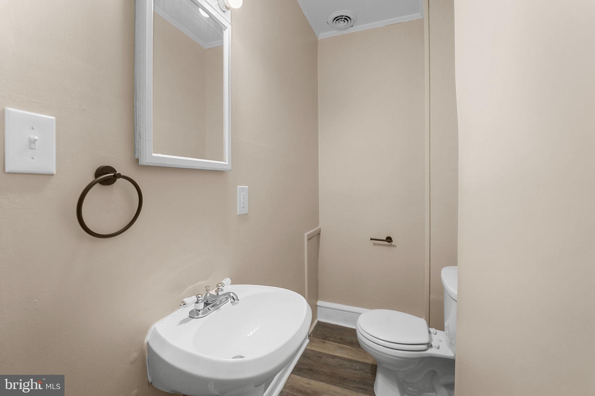 237 Morris Street Gloucester City, NJ 08030 - Photo 14 of 44 a bathroom with a sink a toilet and a mirror