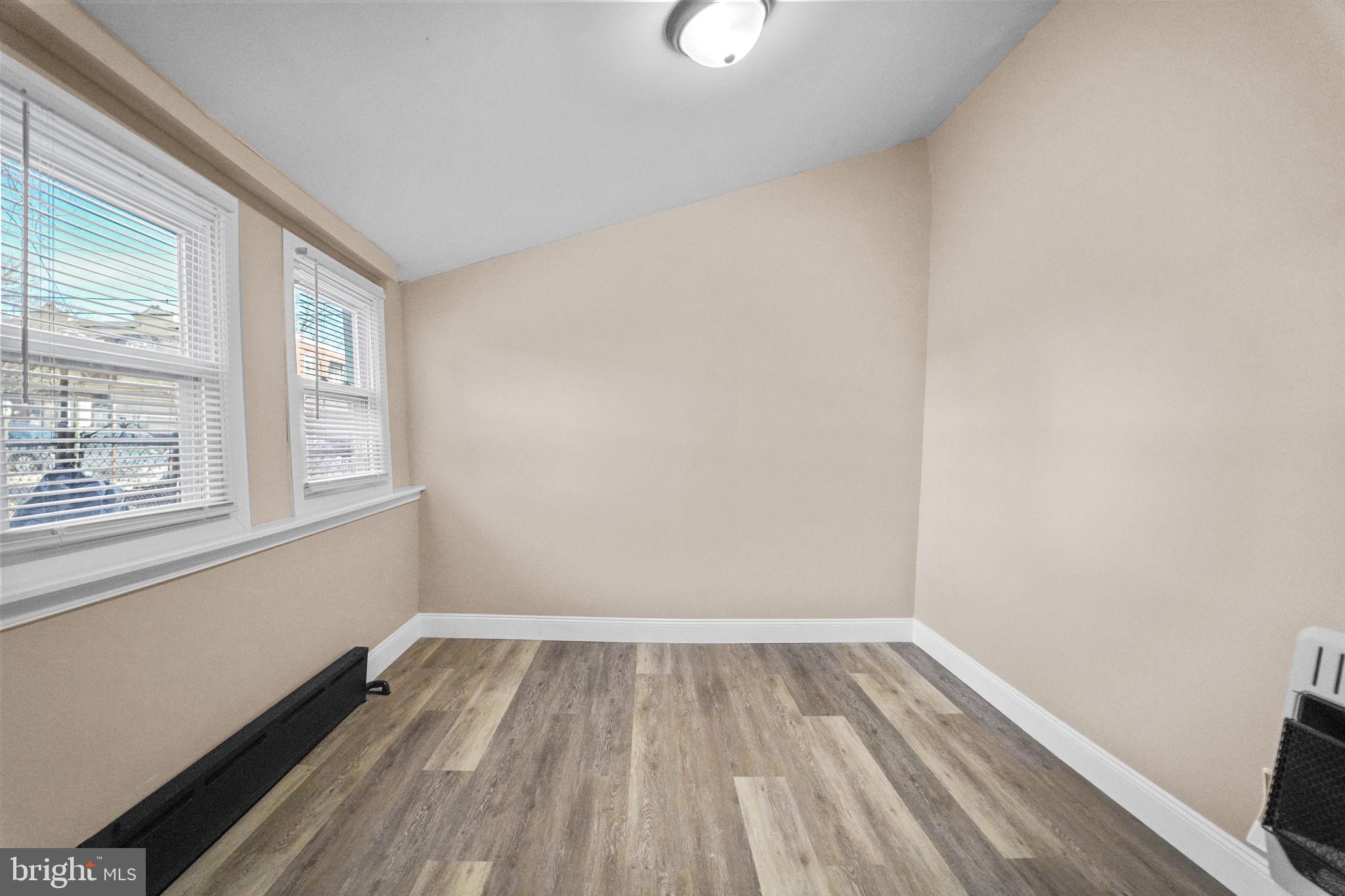 237 Morris Street Gloucester City, NJ 08030 - Photo 18 of 44 a view of a room with wooden floor and windows