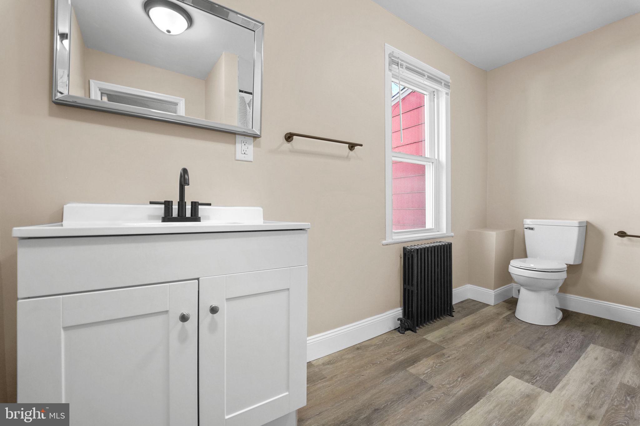 237 Morris Street Gloucester City, NJ 08030 - Photo 22 of 44 a bathroom with a sink toilet vanity and mirror