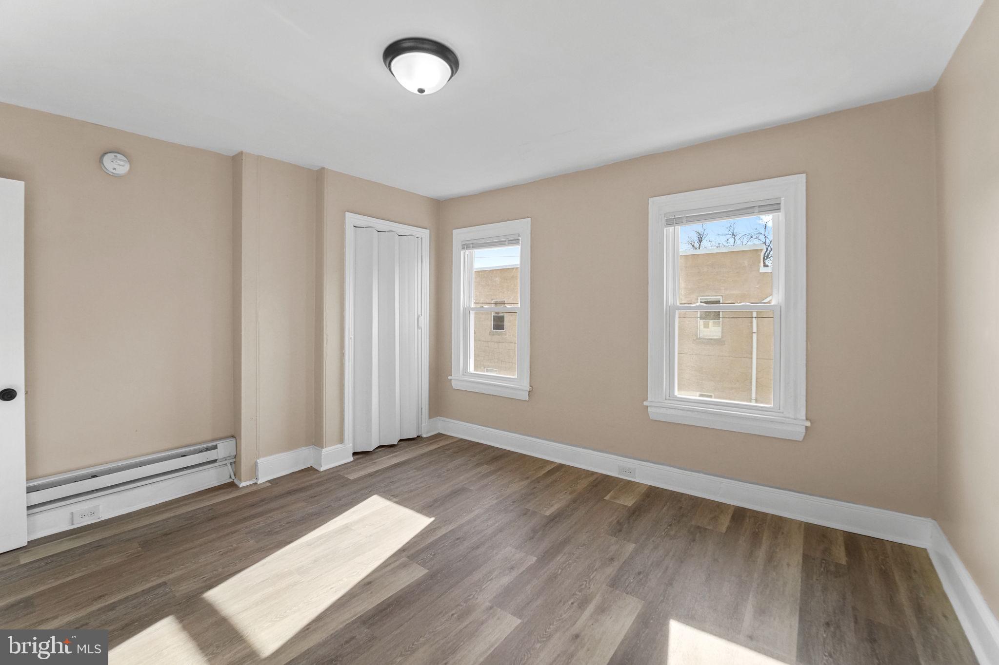 237 Morris Street Gloucester City, NJ 08030 - Photo 25 of 44 an empty room with wooden floor and windows