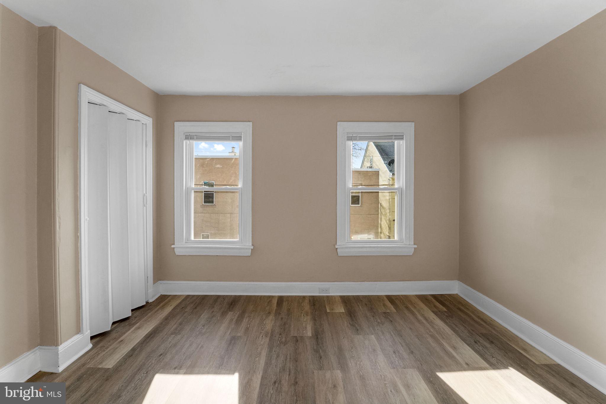 237 Morris Street Gloucester City, NJ 08030 - Photo 27 of 44 an empty room with wooden floor and windows