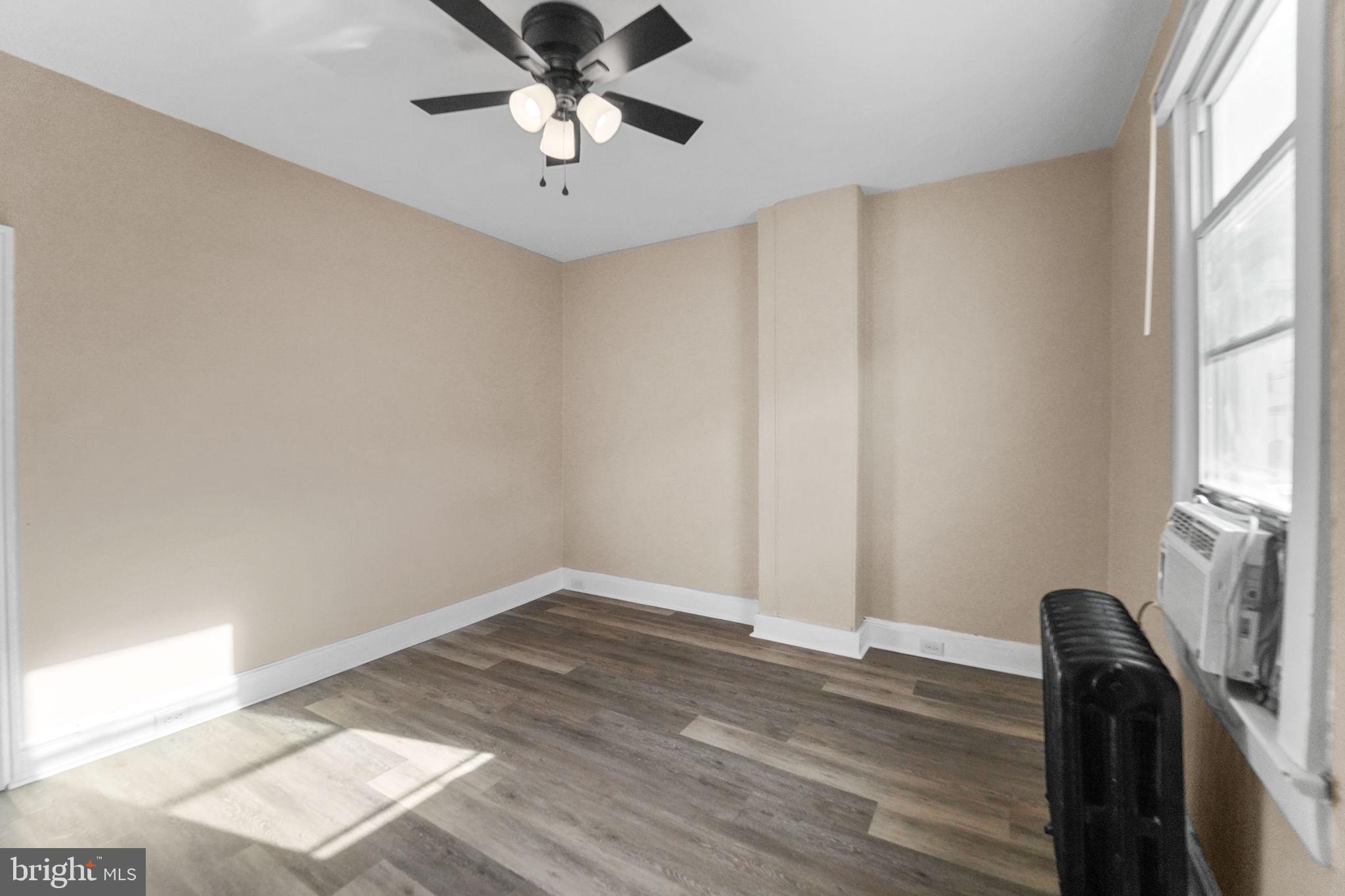 237 Morris Street Gloucester City, NJ 08030 - Photo 4 of 44 a view of empty room with wooden floor and fan
