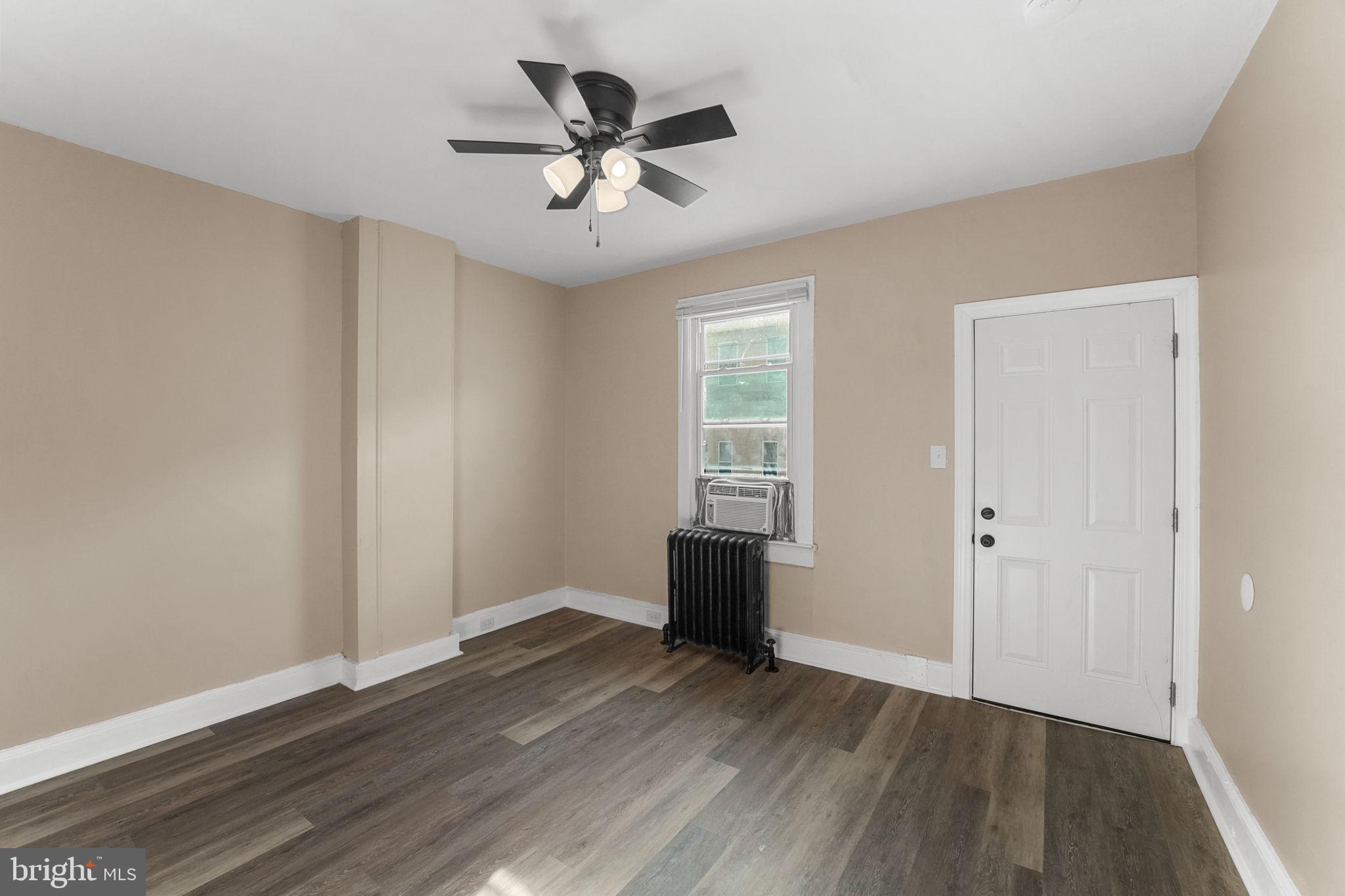 237 Morris Street Gloucester City, NJ 08030 - Photo 5 of 44 an empty room with wooden floor and windows