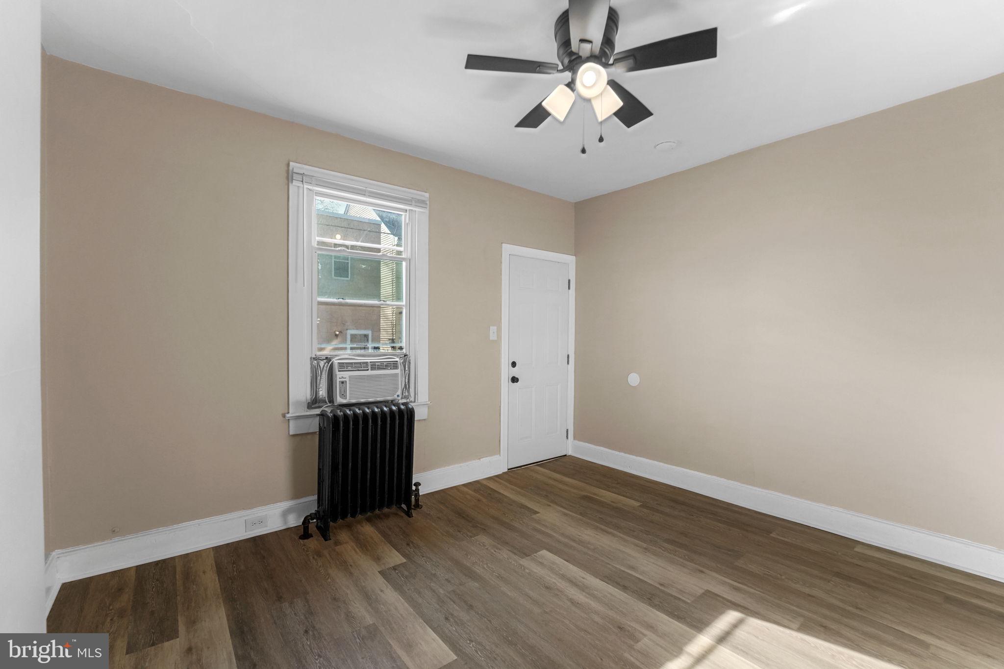 237 Morris Street Gloucester City, NJ 08030 - Photo 8 of 44 wooden floor in an empty room with a window