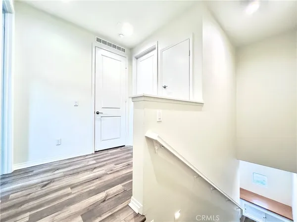 a view of storage and utility room with wooden floor