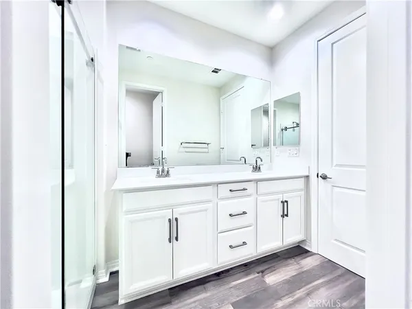 a spacious bathroom with a double vanity sink and a mirror