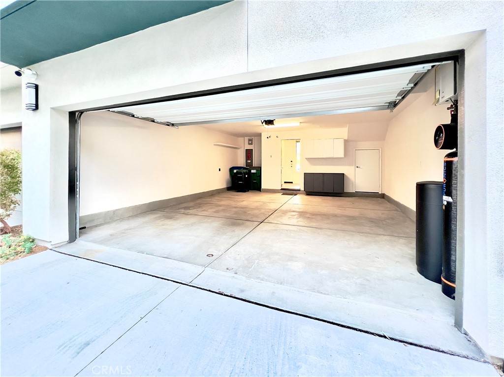110 Keeper Irvine, CA 92618 - Photo 28 of 32 Attached two-car garage with water softening system, EV car charging, and storage area