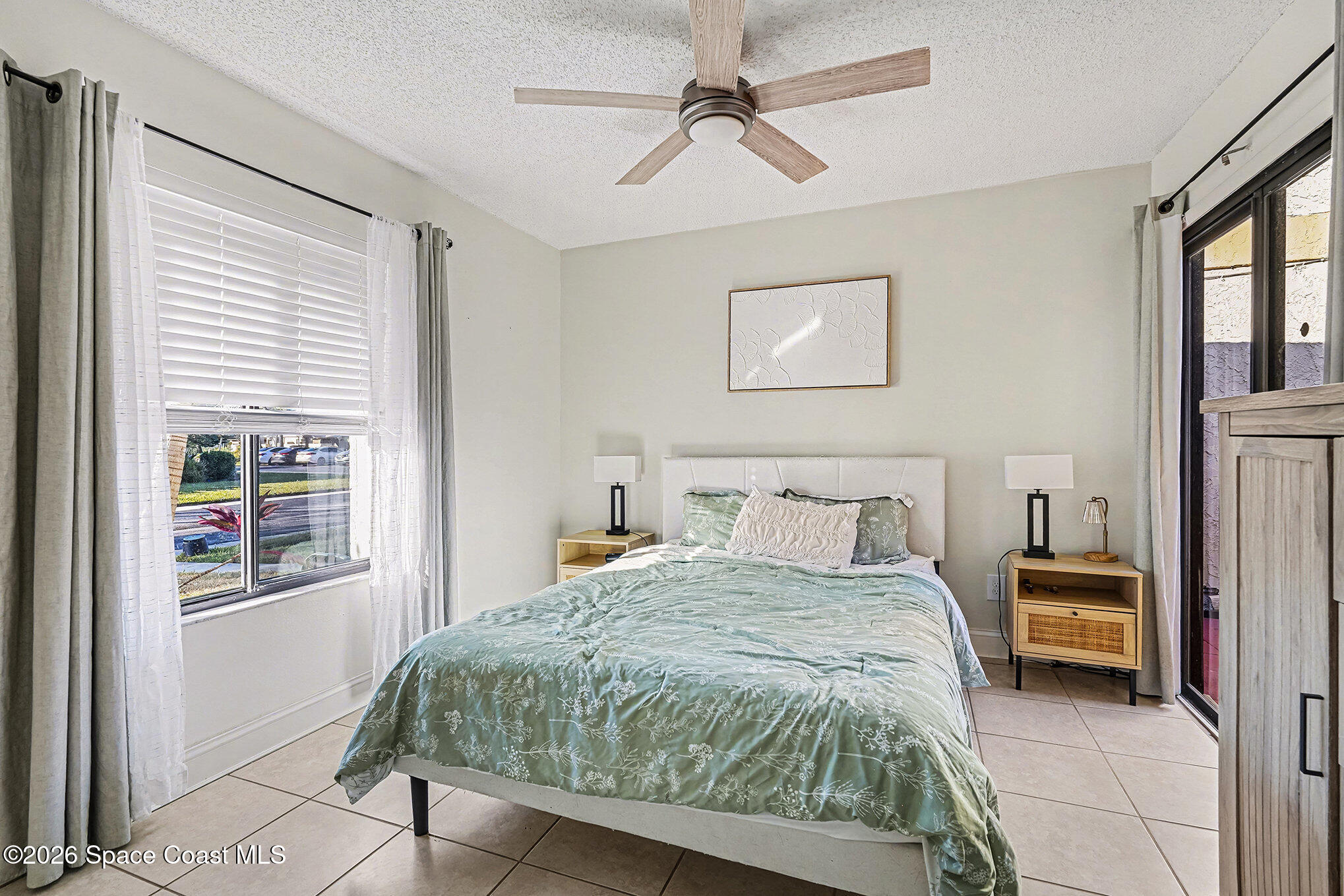 1491 Sheafe Avenue Northeast, Unit 104 Palm Bay, FL 32905 - Photo 11 of 19 a bedroom with a bed and a window