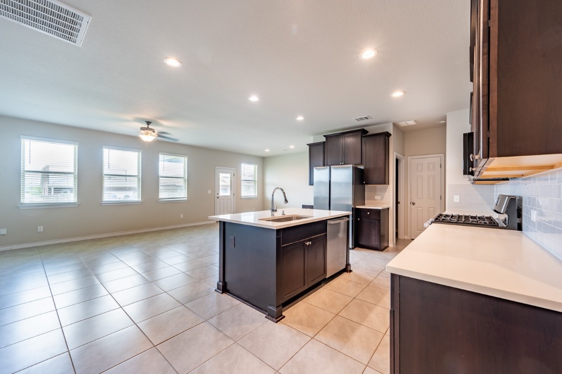 1325 Eagle Ray Street Leander, TX 78641 - Photo 3 of 16 a kitchen with stainless steel appliances granite countertop a stove and a refrigerator