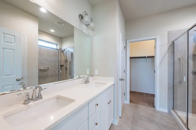 a bathroom with a double vanity sink mirror and double