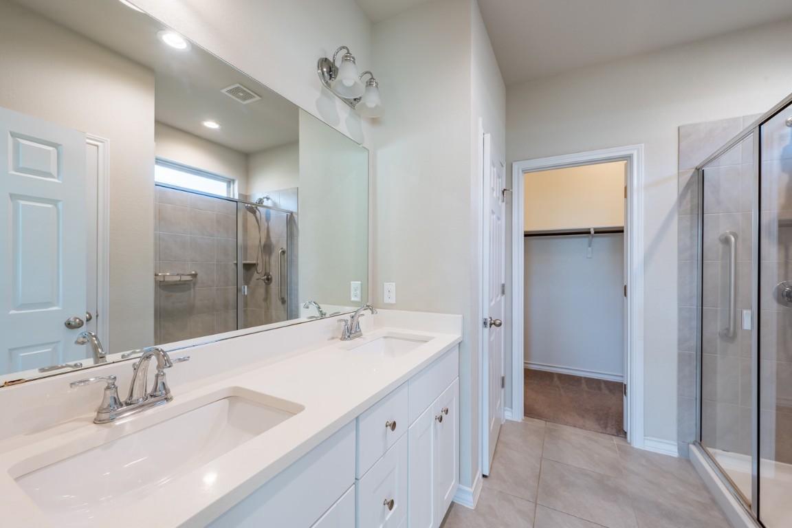 1325 Eagle Ray Street Leander, TX 78641 - Photo 8 of 16 a bathroom with a double vanity sink mirror and double