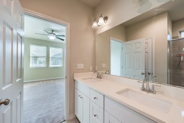 a bathroom with a sink double vanity and a mirror