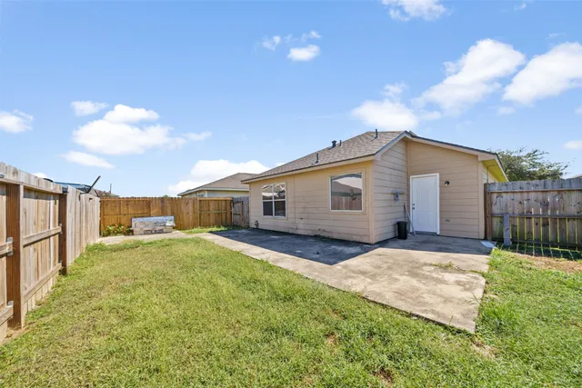a view of a backyard with wooden fence