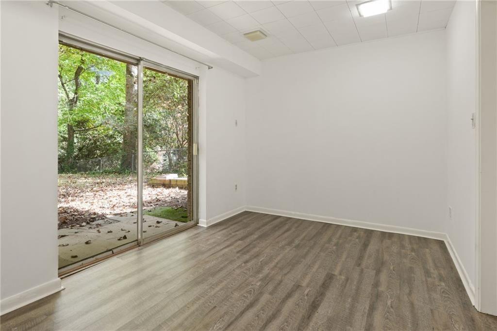 705 Edgewater Trail Sandy Springs, GA 30328 - Photo 31 of 36 an empty room with wooden floor and windows