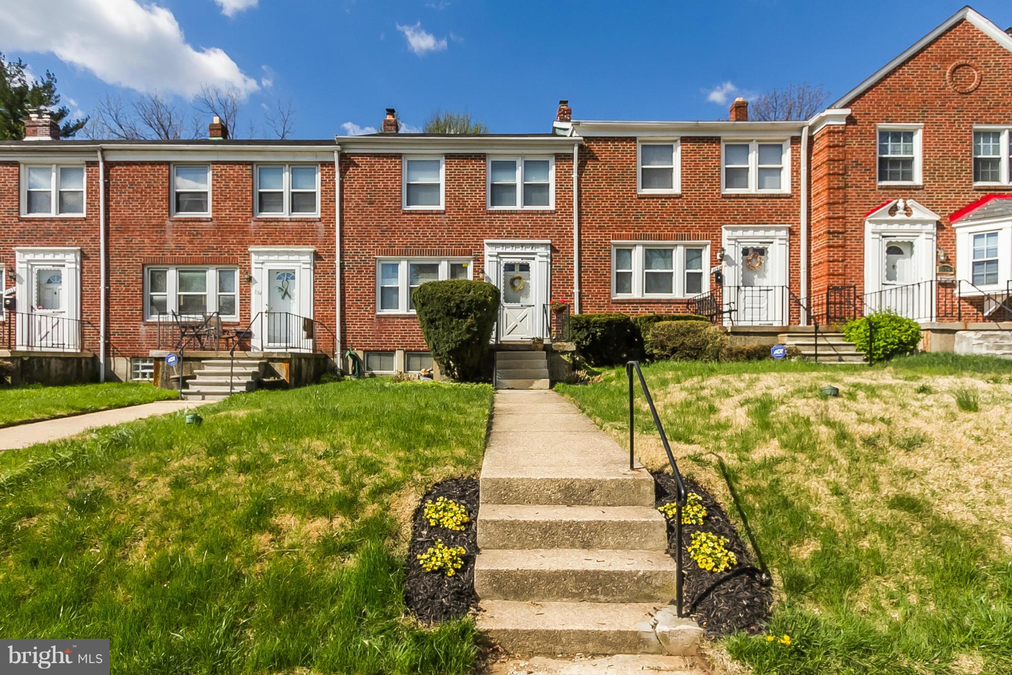 1156 Newfield Road Baltimore, MD 21207 - Photo 1 of 23 a front view of a house with a yard