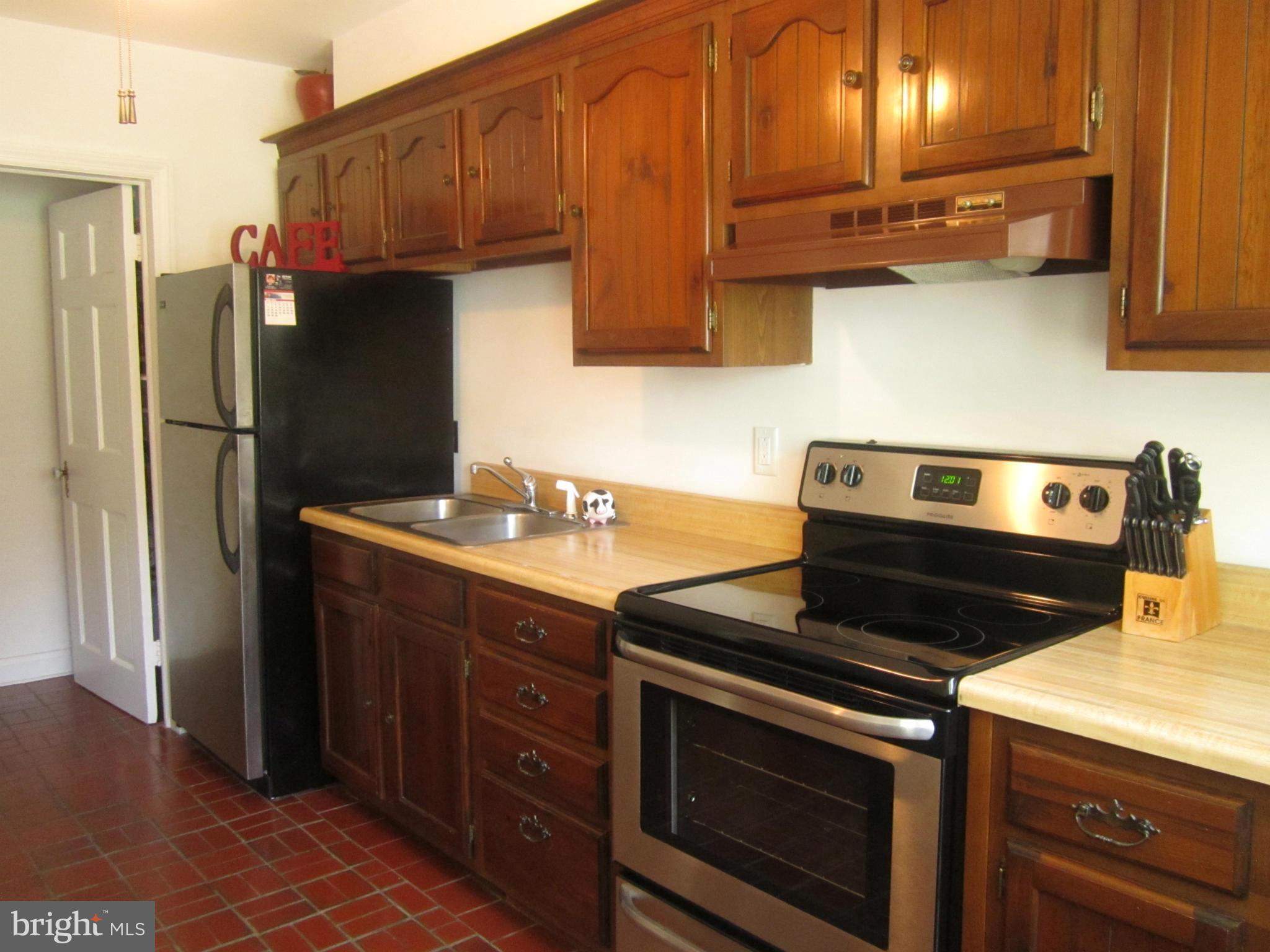 1156 Newfield Road Baltimore, MD 21207 - Photo 11 of 23 a kitchen with stainless steel appliances granite countertop a stove a refrigerator and a sink