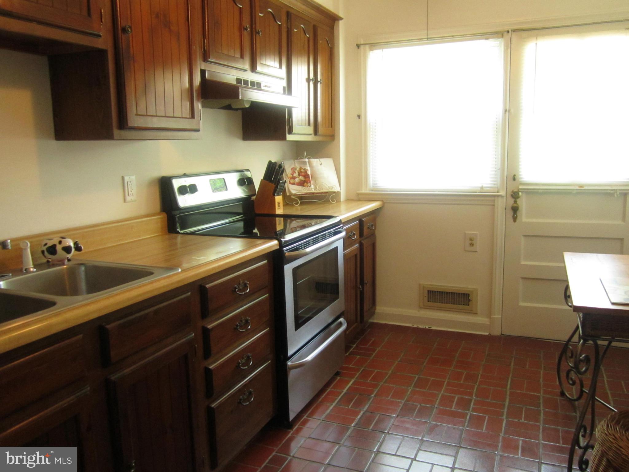 1156 Newfield Road Baltimore, MD 21207 - Photo 12 of 23 a kitchen with stainless steel appliances a sink stove and cabinets