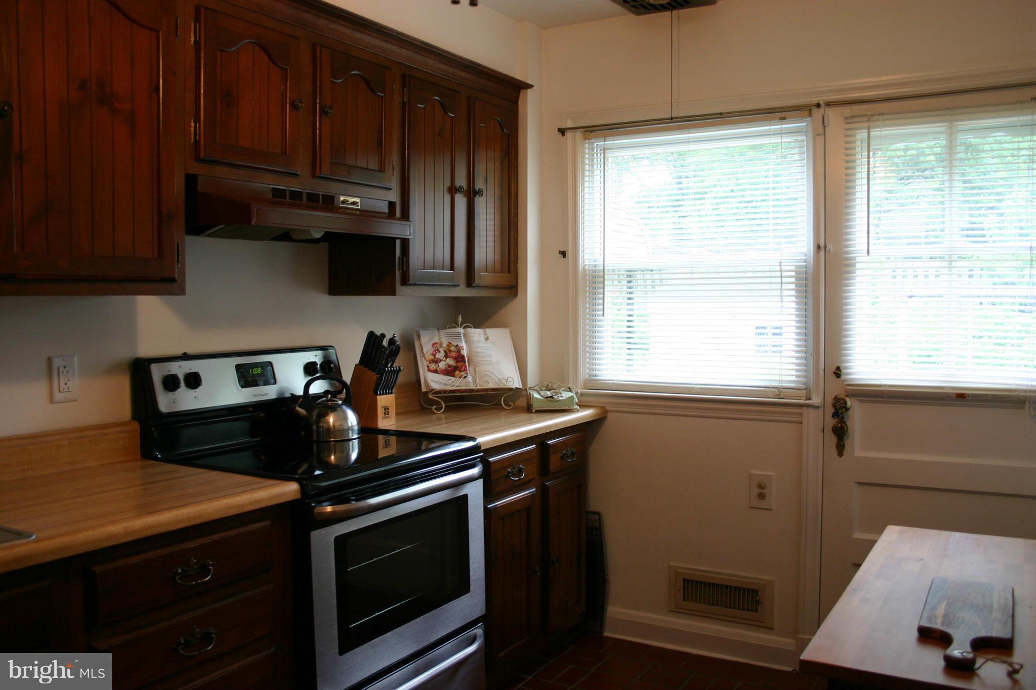 1156 Newfield Road Baltimore, MD 21207 - Photo 13 of 23 a kitchen with a stove and a microwave