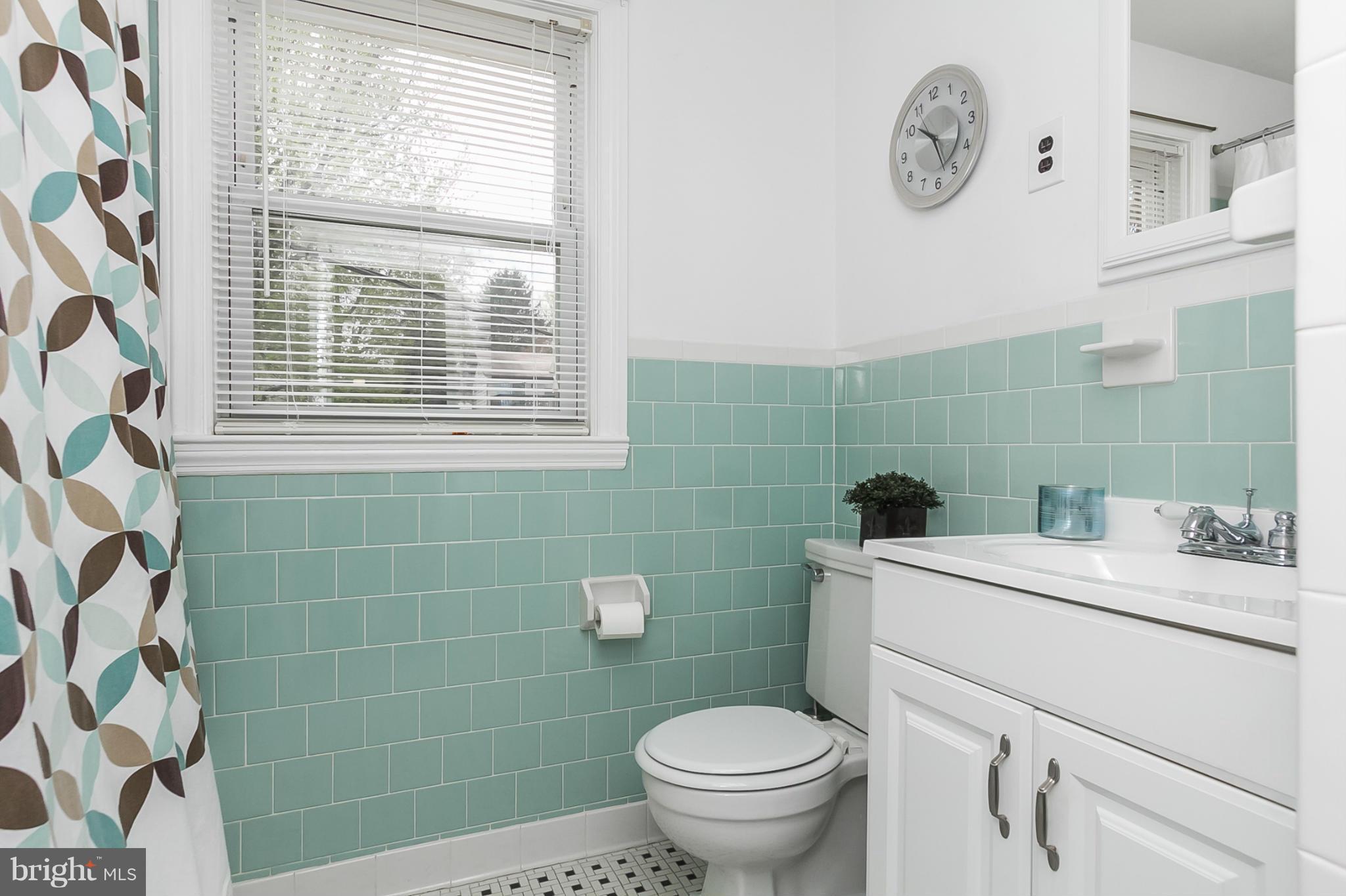 1156 Newfield Road Baltimore, MD 21207 - Photo 16 of 23 a bathroom with a sink a toilet and a mirror