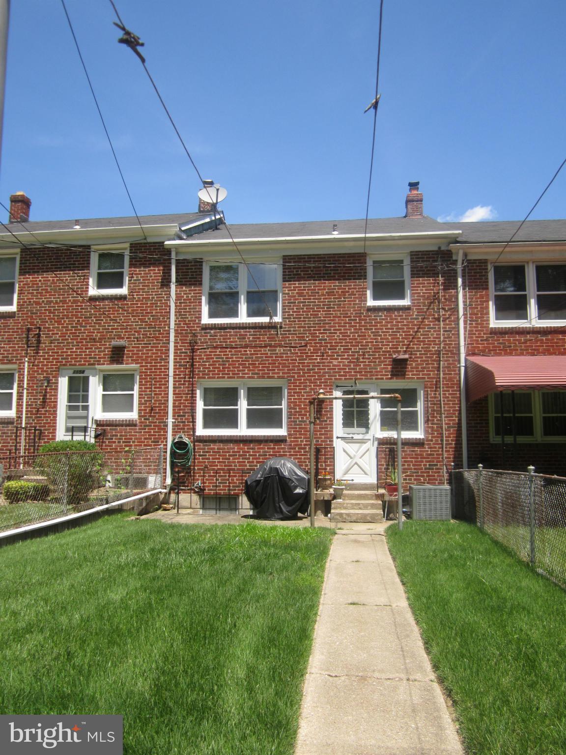 1156 Newfield Road Baltimore, MD 21207 - Photo 3 of 23 a front view of a house with a yard