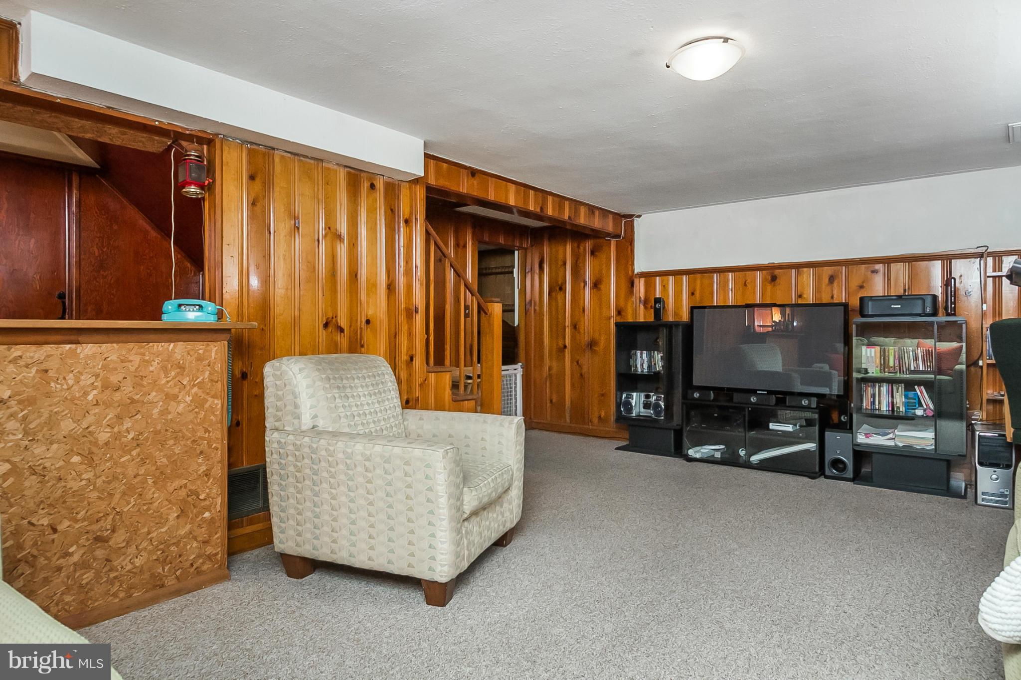 1156 Newfield Road Baltimore, MD 21207 - Photo 21 of 23 a living room with furniture and a flat screen tv