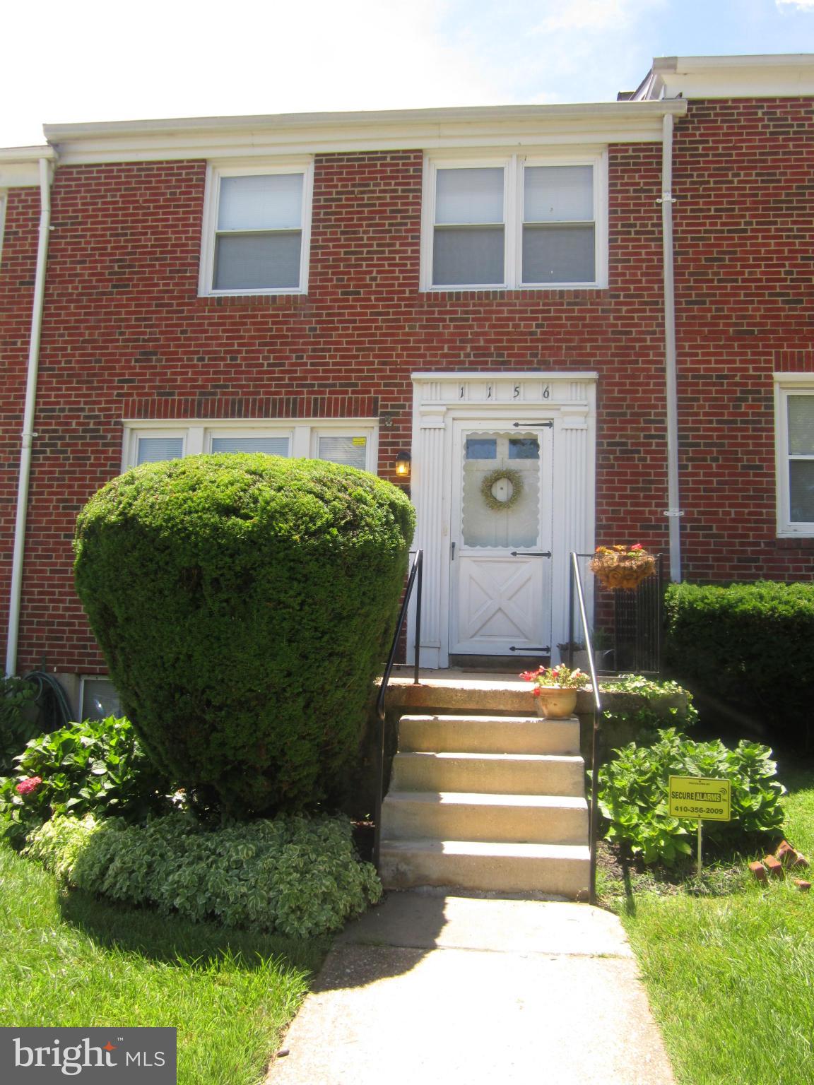 1156 Newfield Road Baltimore, MD 21207 - Photo 4 of 23 a front view of a house with a garden