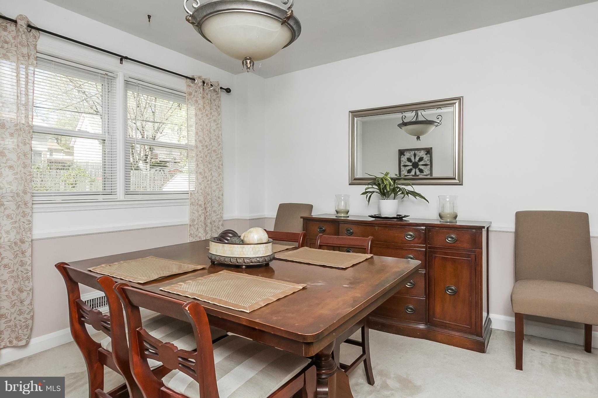 1156 Newfield Road Baltimore, MD 21207 - Photo 7 of 23 a view of a dining room with furniture window and wooden floor