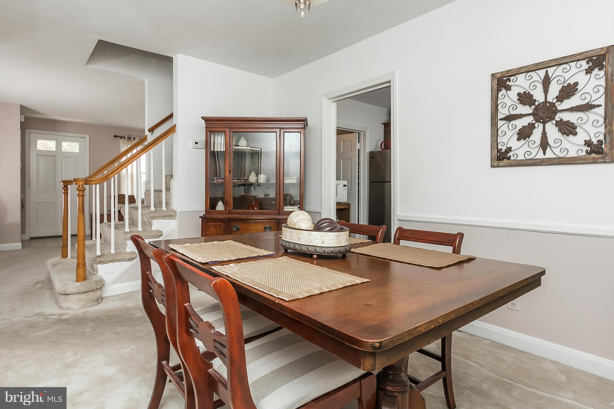 1156 Newfield Road Baltimore, MD 21207 - Photo 8 of 23 a dining room with furniture and wooden floor