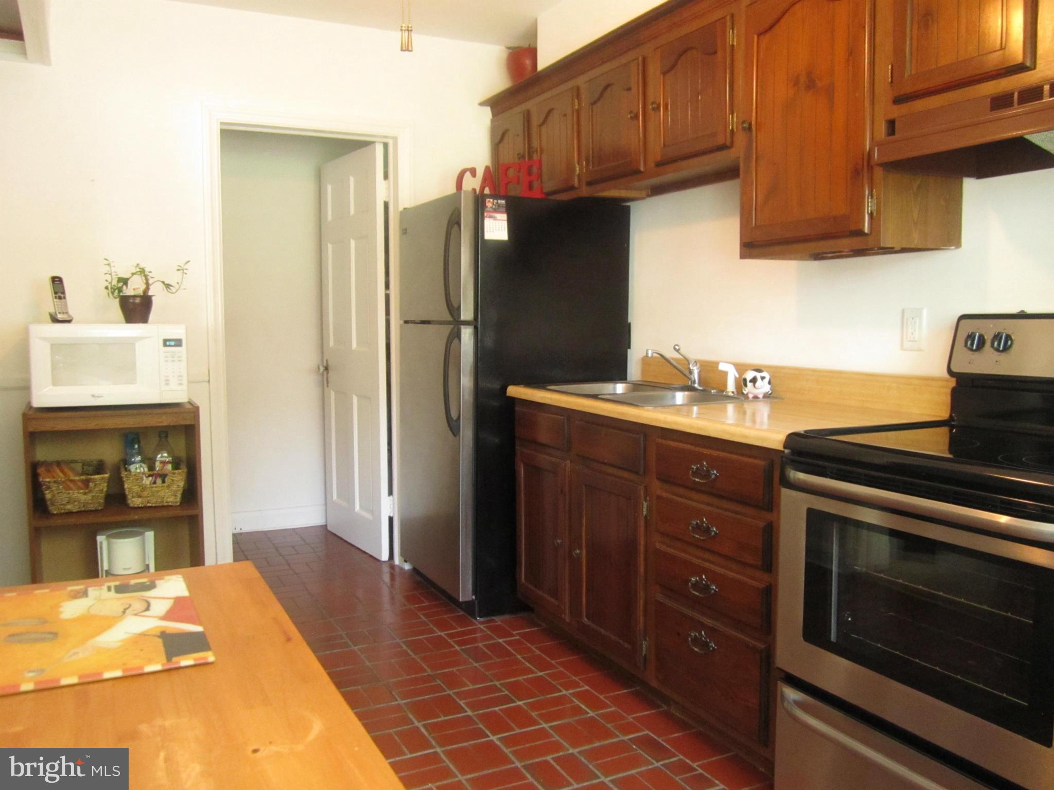 1156 Newfield Road Baltimore, MD 21207 - Photo 10 of 23 a kitchen with stainless steel appliances granite countertop a refrigerator and a stove