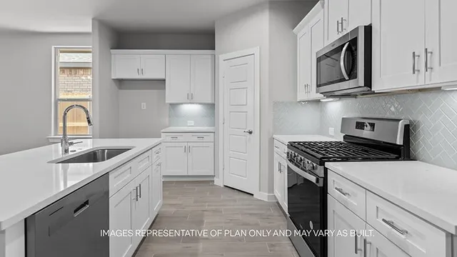 a kitchen with stainless steel appliances granite countertop a sink stove oven and refrigerator