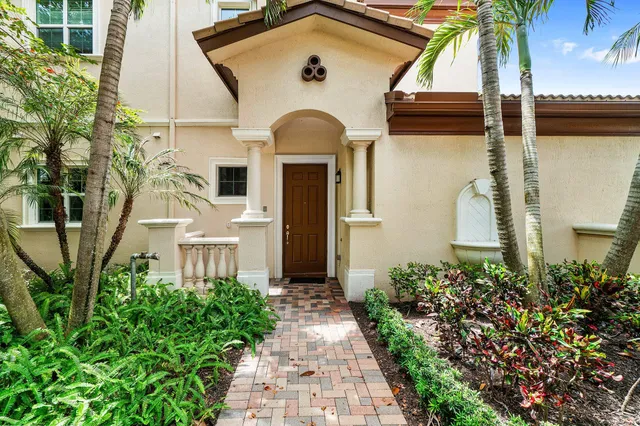 a kitchen with a stove a kitchen island a dining table and chairs with wooden floor