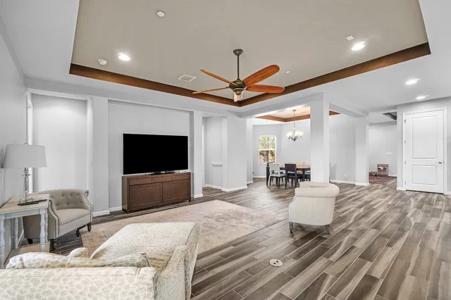 a kitchen with stainless steel appliances kitchen island a wooden floor and white cabinets