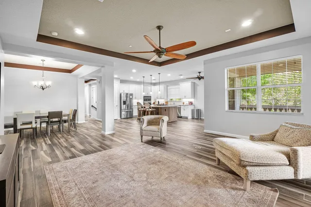 a front view of a house with a garden and trees