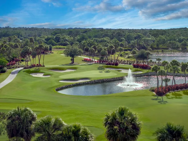 a front view of a house with a garden and yard