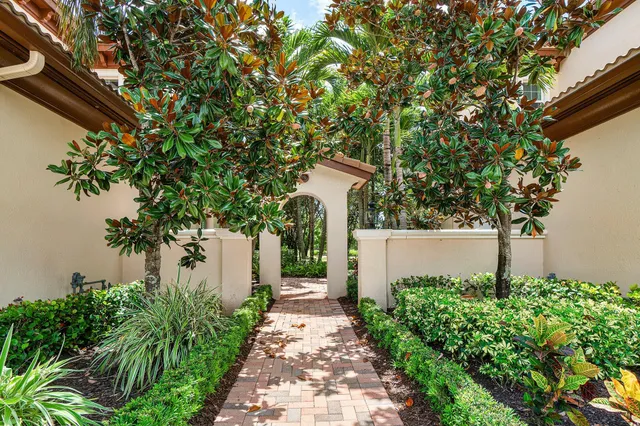 a kitchen with stainless steel appliances kitchen island granite countertop a wooden floor and white cabinets