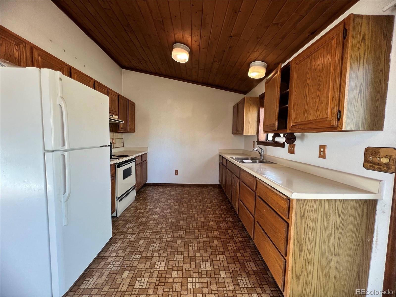 52 Deer Trail Drive Bailey, CO 80421 - Photo 12 of 40 a kitchen with sink a refrigerator and a stove