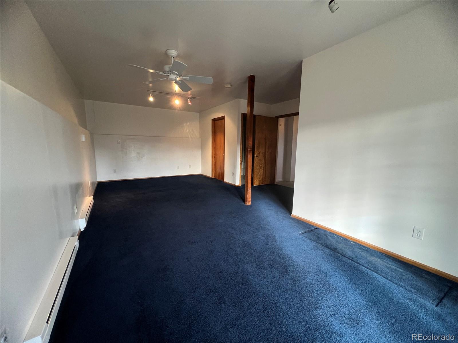 52 Deer Trail Drive Bailey, CO 80421 - Photo 21 of 40 an empty room with wooden floor and windows