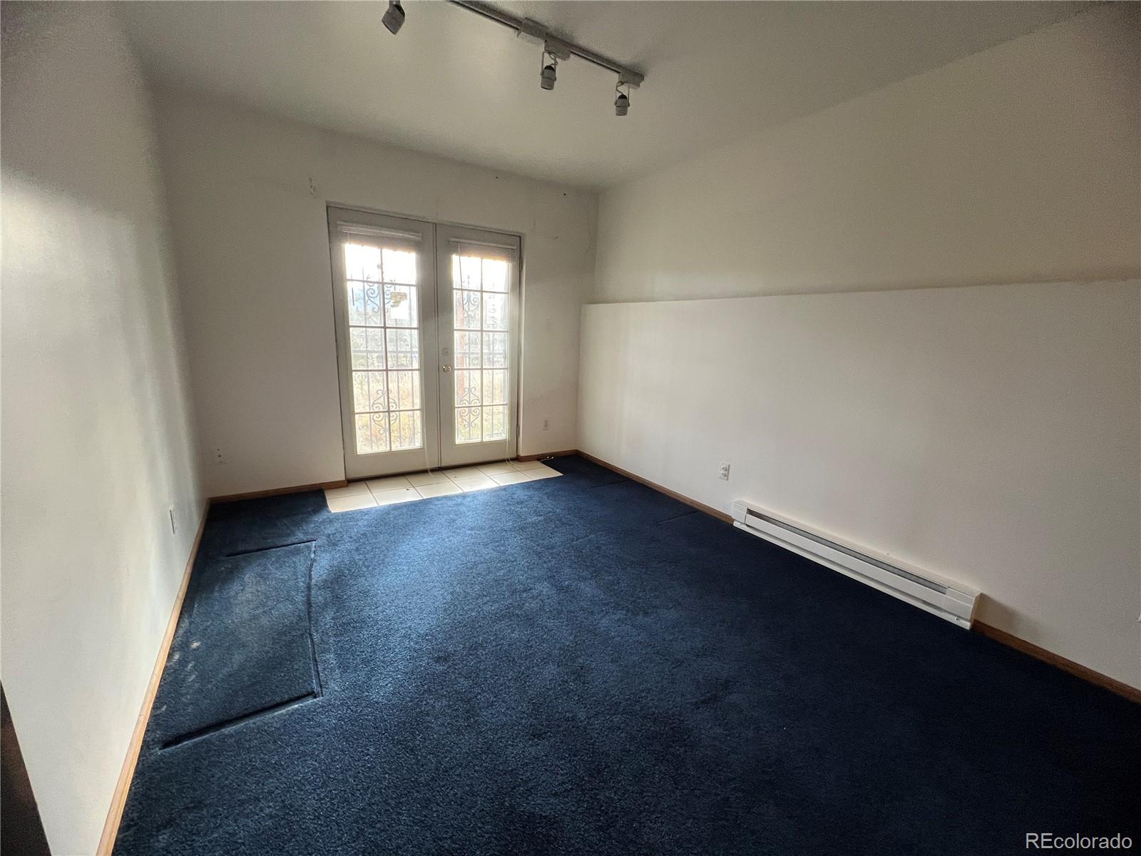 52 Deer Trail Drive Bailey, CO 80421 - Photo 22 of 40 an empty room with wooden floor and windows