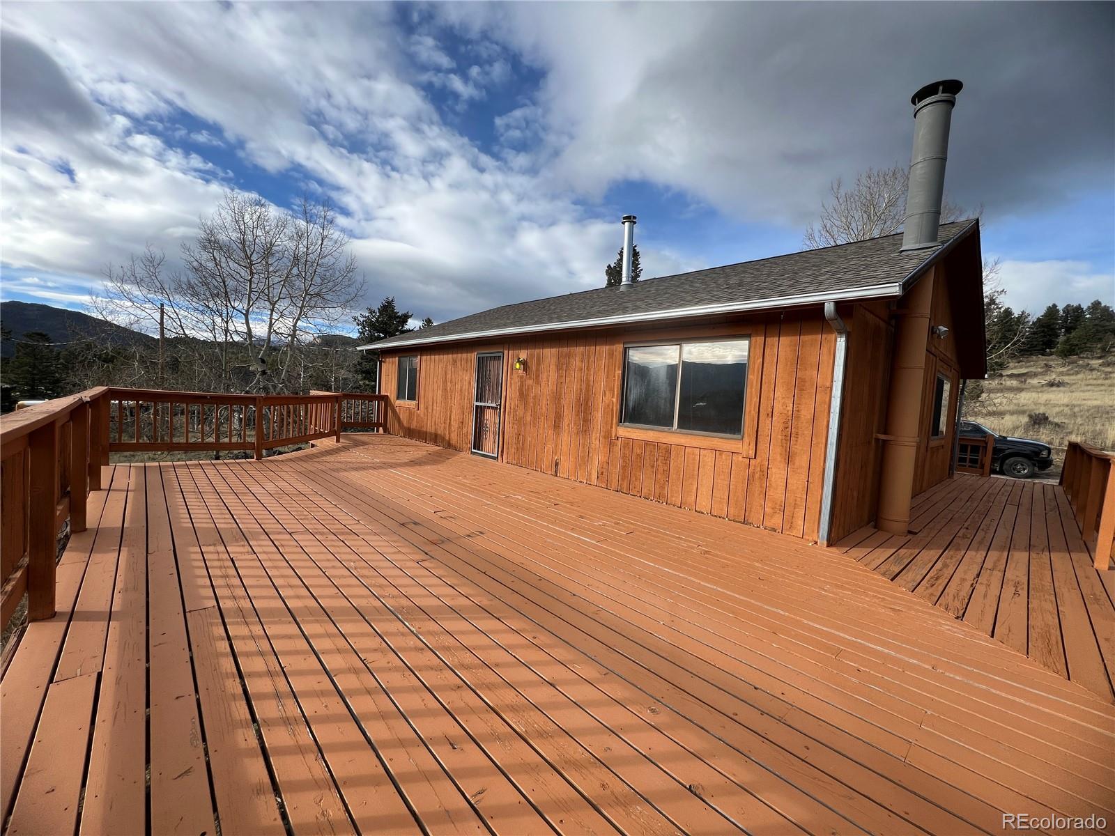 52 Deer Trail Drive Bailey, CO 80421 - Photo 26 of 40 a bedroom with a bed and wooden floor