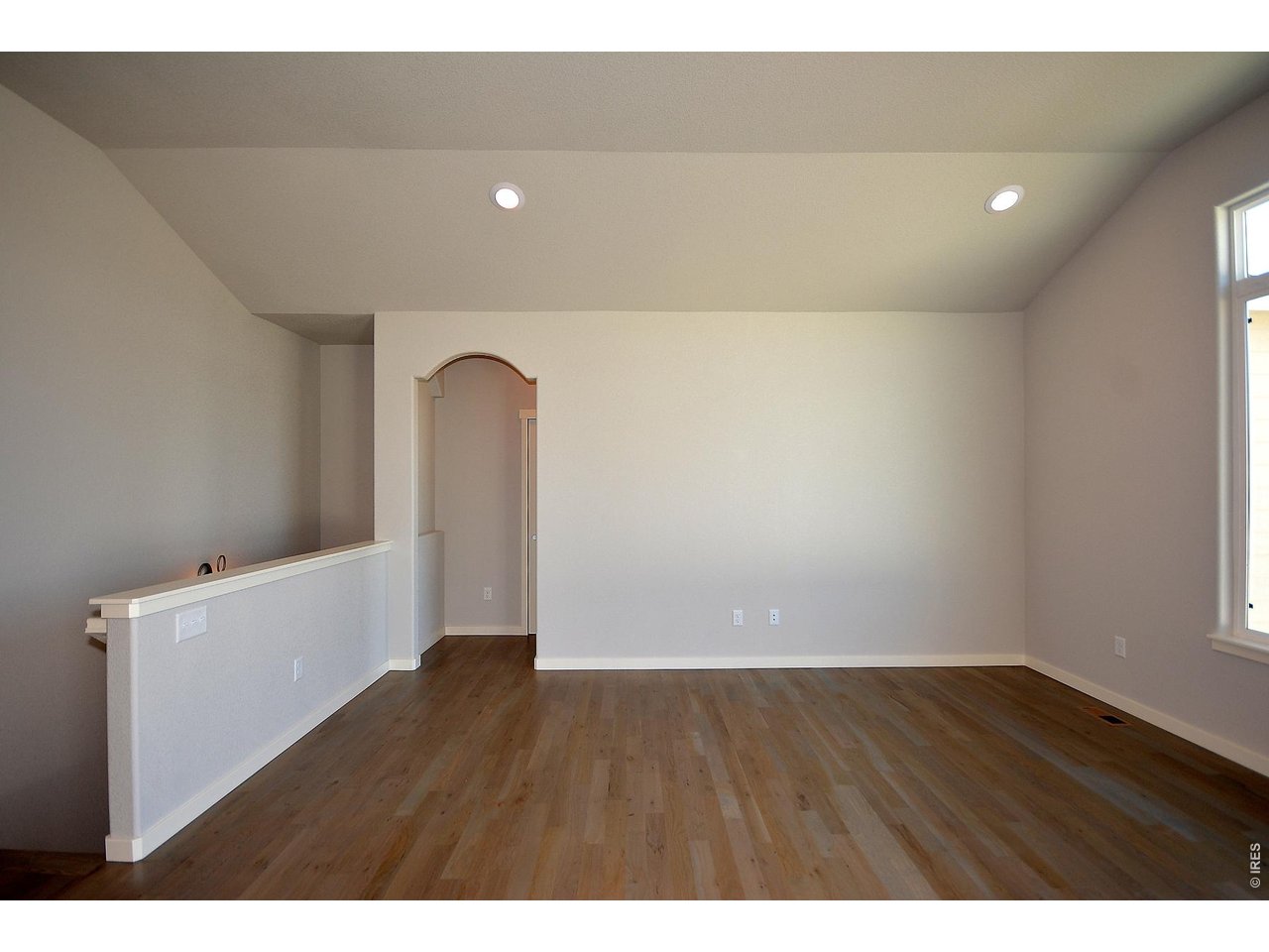 1145 Bitterroot Court Johnstown, CO 80534 - Photo 11 of 31 a view of empty room with wooden floor