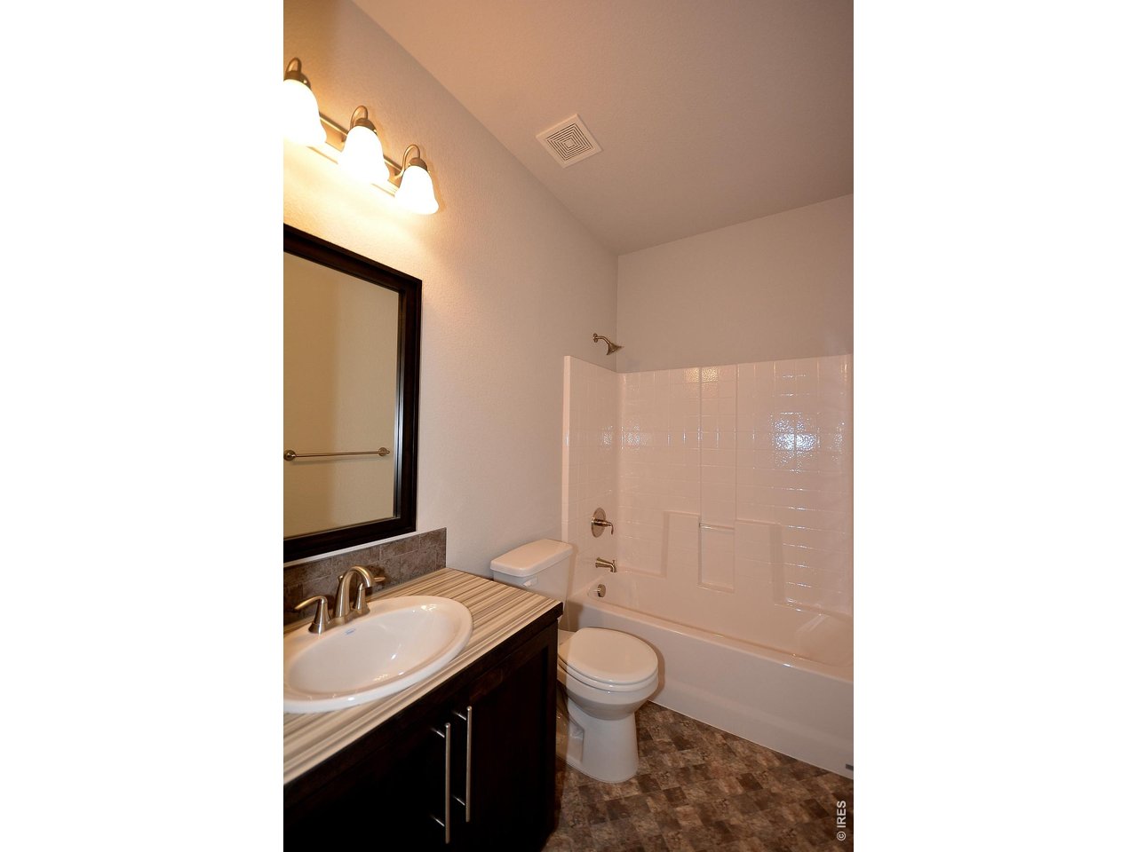 1145 Bitterroot Court Johnstown, CO 80534 - Photo 23 of 31 a bathroom with a toilet sink a mirror and shower