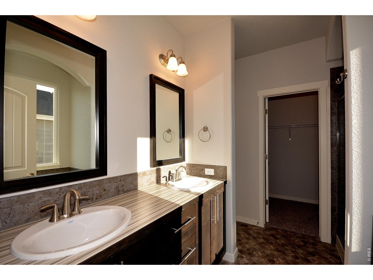 1145 Bitterroot Court Johnstown, CO 80534 - Photo 27 of 31 a bathroom with a sink and a mirror
