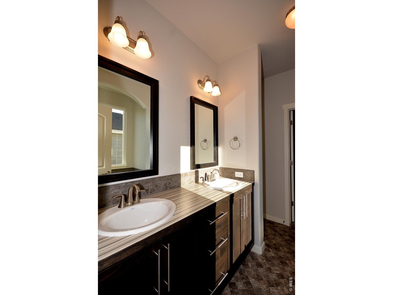 1145 Bitterroot Court Johnstown, CO 80534 - Photo 29 of 31 a bathroom with a sink and a mirror