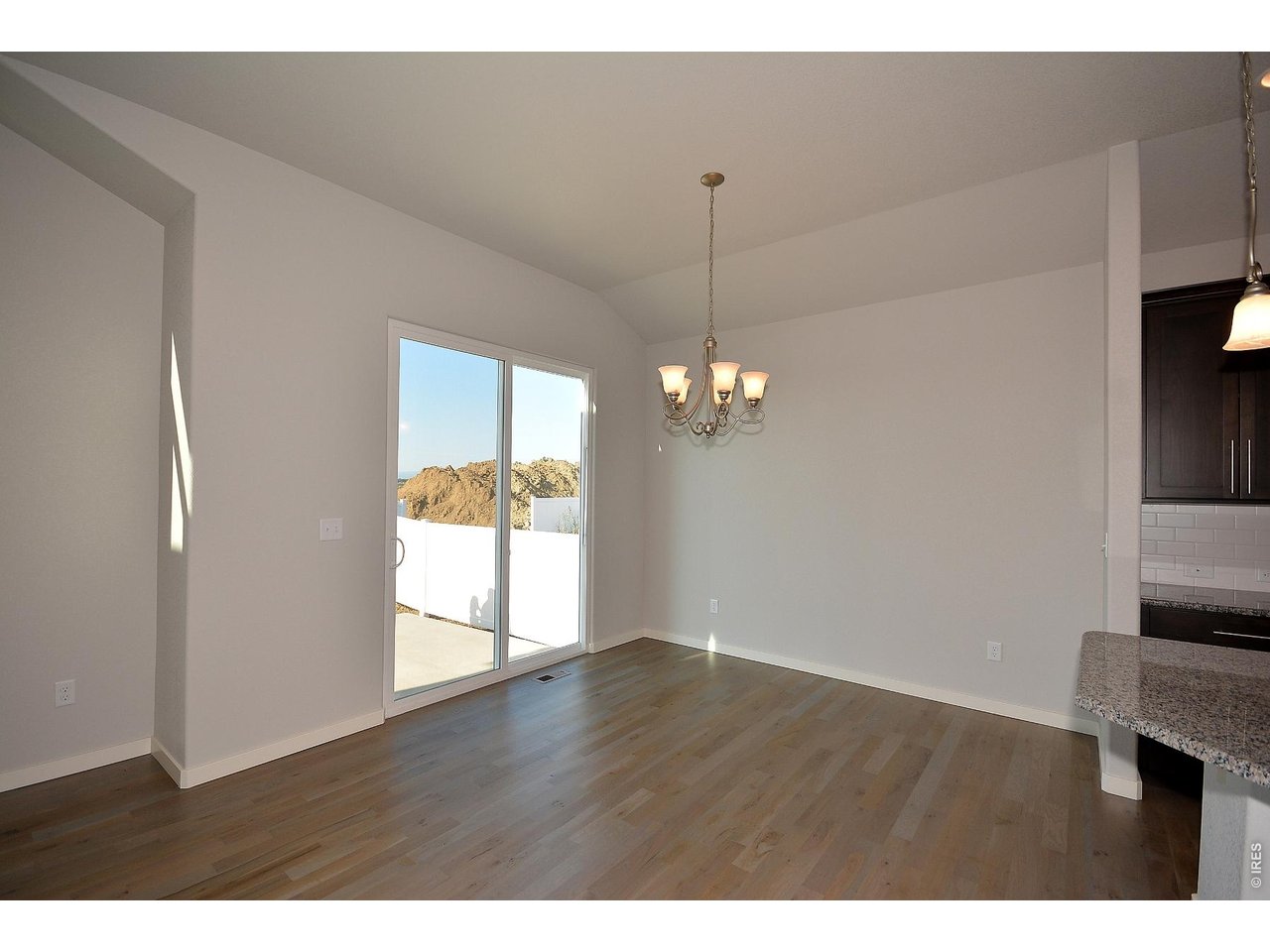 1145 Bitterroot Court Johnstown, CO 80534 - Photo 10 of 31 a view of empty room with wooden floor and fan