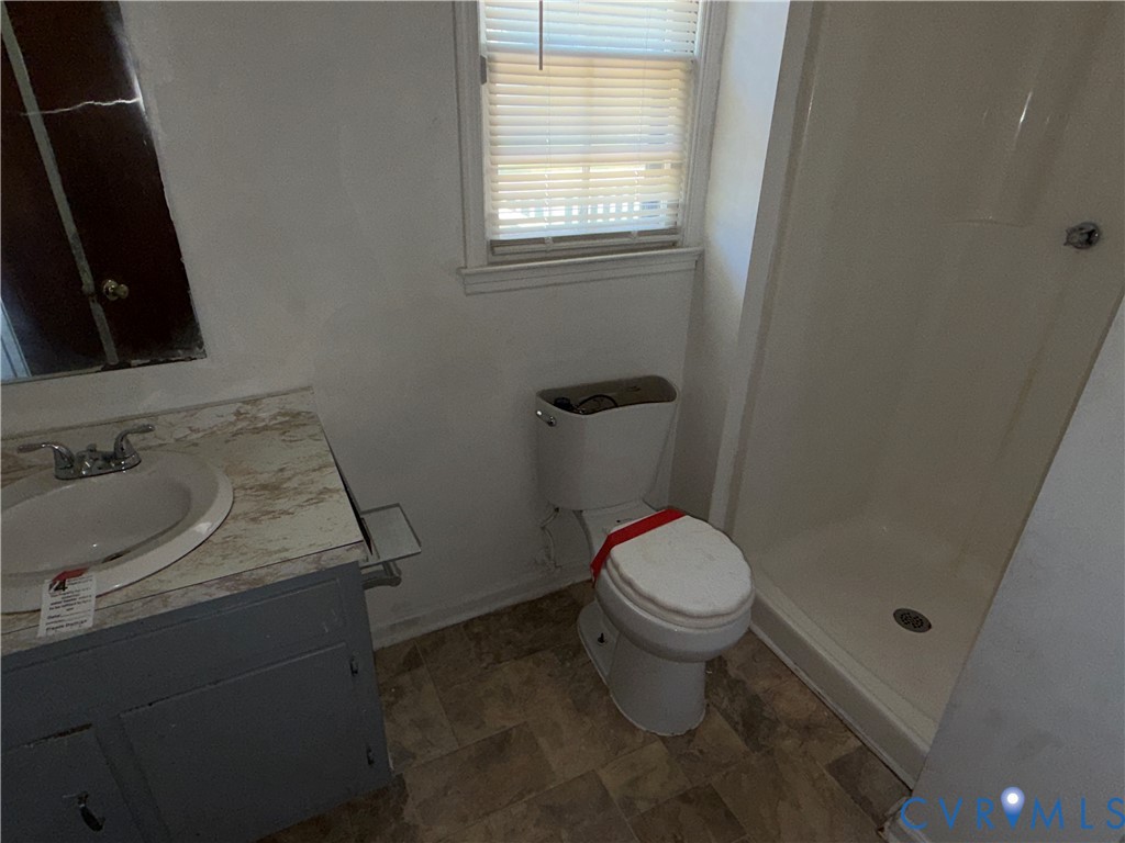 1607 Old Iron Road Hopewell, VA 23860 - Photo 5 of 12 a bathroom with a sink toilet and window