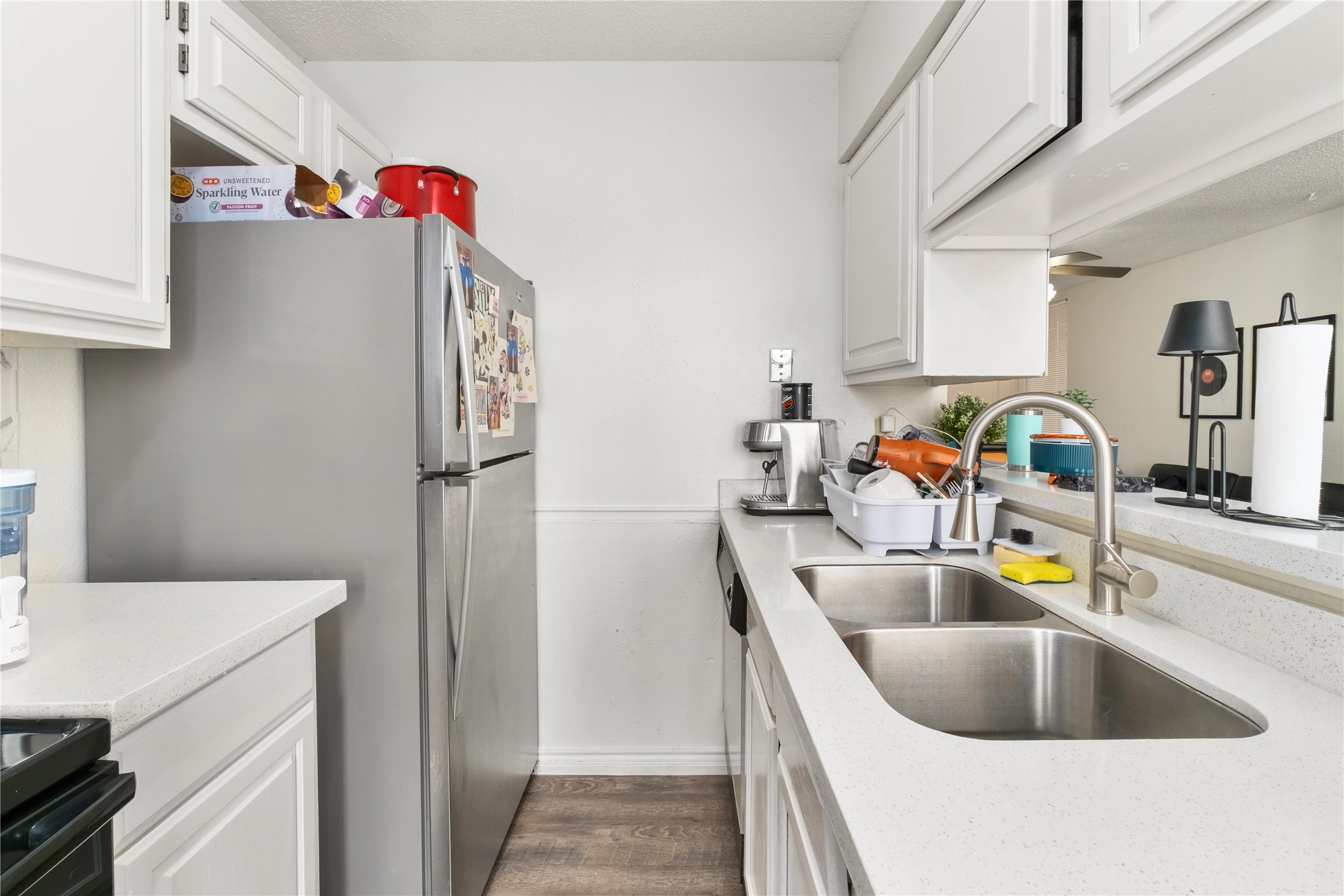 2409 Leon Street, Unit 307 Austin, TX 78705 - Photo 9 of 23 a kitchen with a sink and a refrigerator