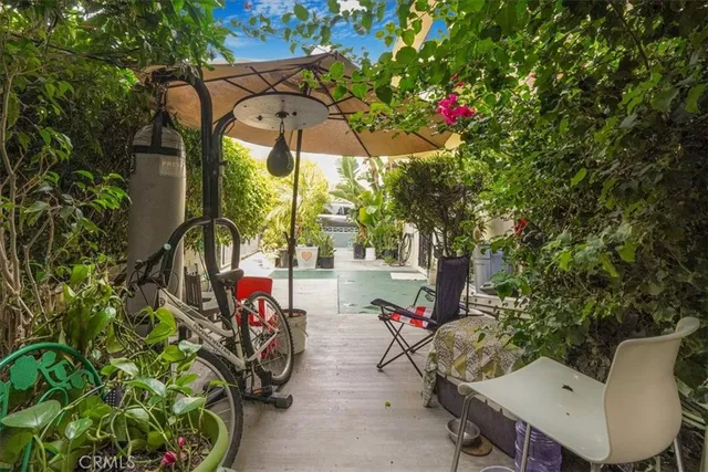 a view of a chair and tables in the patio