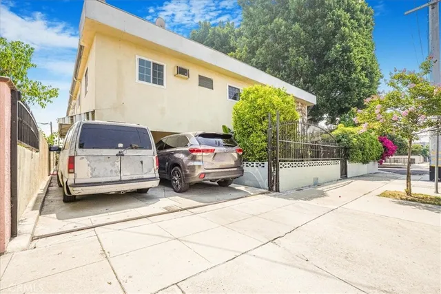 a view of a car park in front of a house